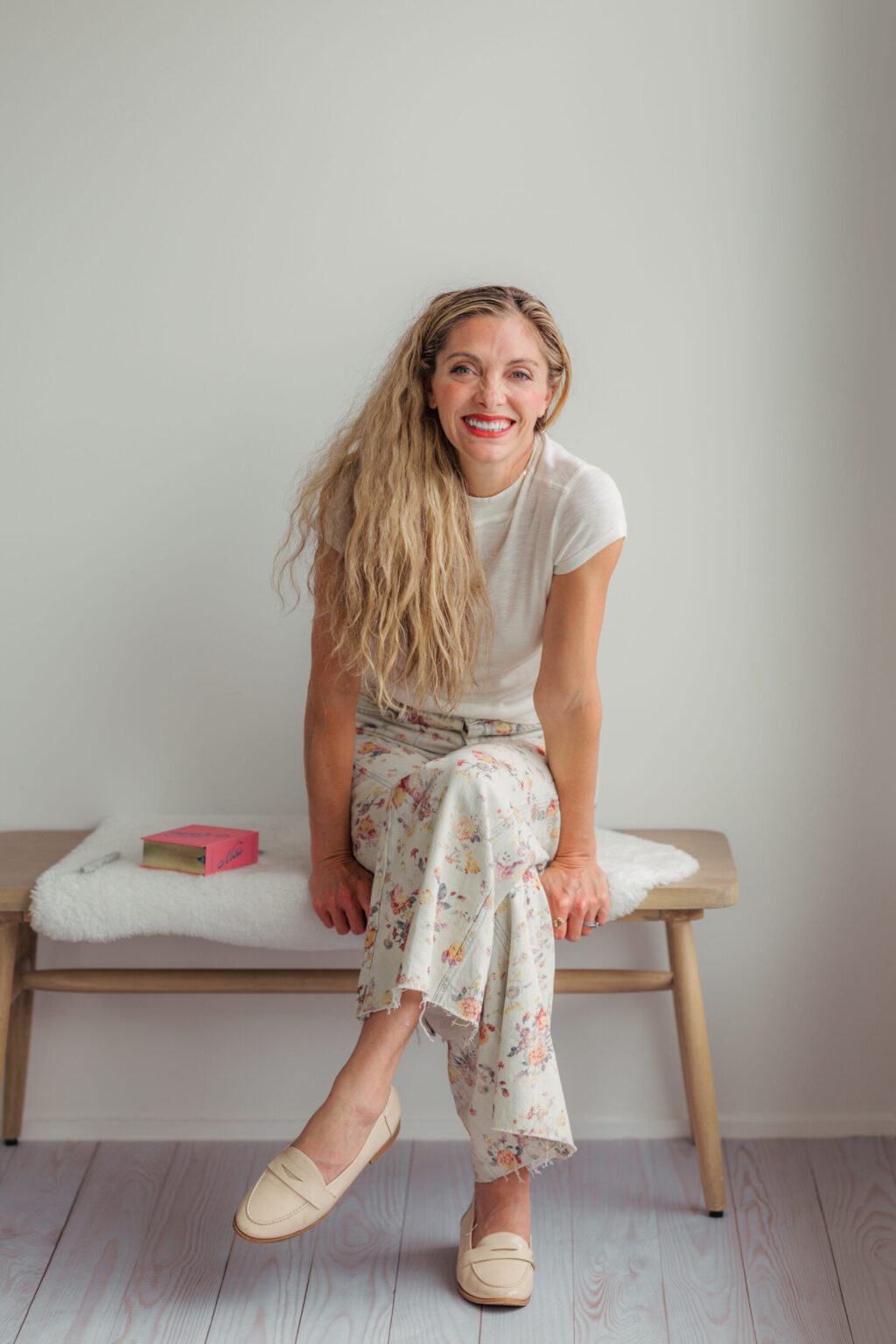 Kathy Patalsky, creator of Finding Vegan, smiling on a wooden bench